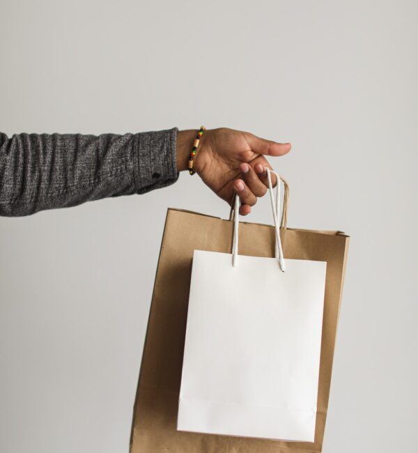 A woman's hand holding shopping bags.
