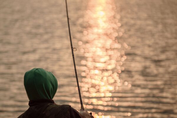 Man fishing at sunset.