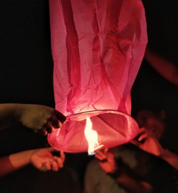 A red paper lantern being lit.